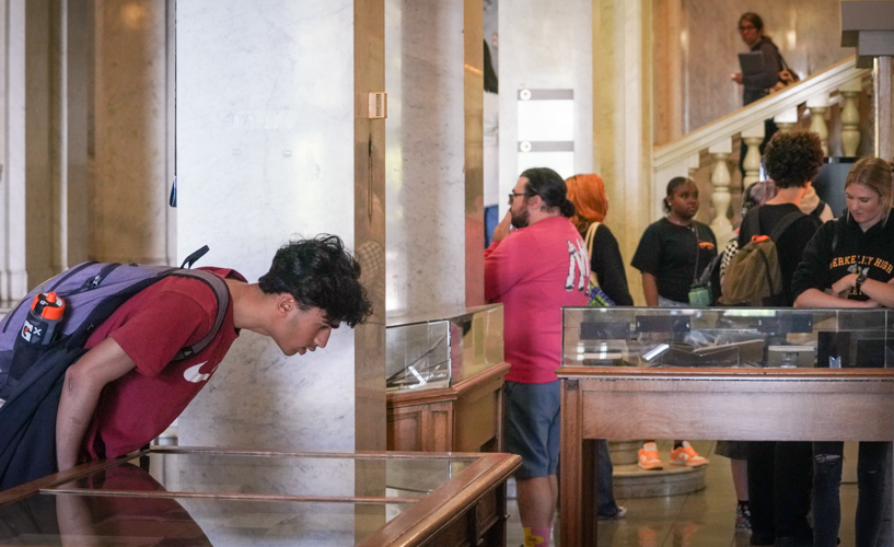 students look at exhibit cases