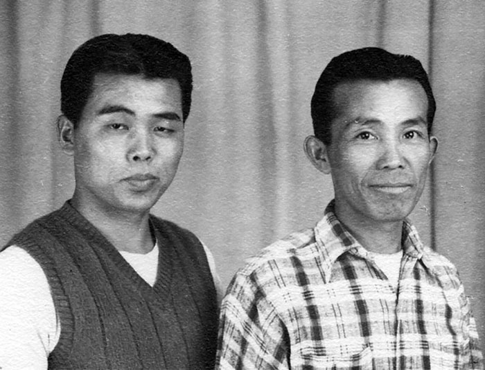 black and white image of two men looking at camera