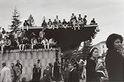 Photo of students sitting on roof of Golden Bear Center during rally, December 1964