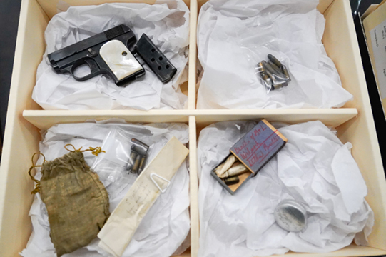 Gun, bullets and other evidence in the collection