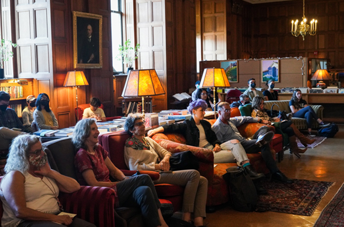 A crowd listens in the Morrison Library