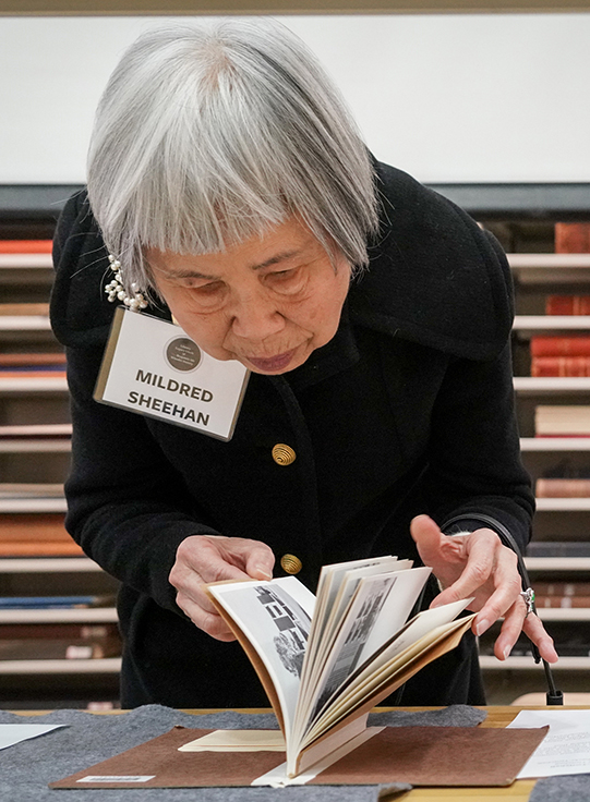 Donor looks closely at a book