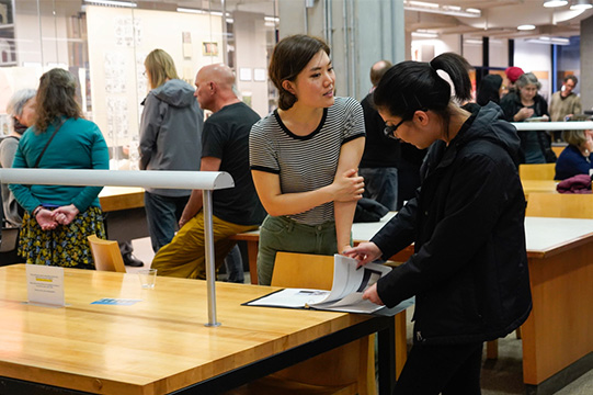 Two attendees chat during the event