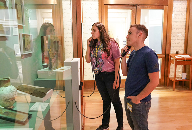 Students listen to audio in the exhibit