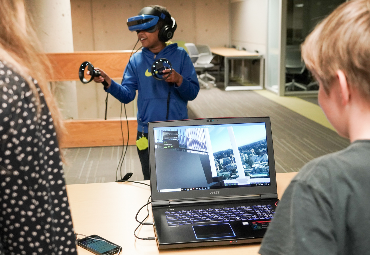 A kid is immersed in virtual reality on Cal Day.