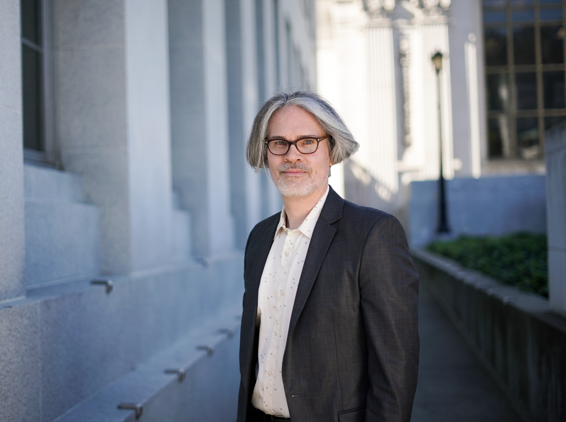 Paul Burnett, a historian at the Oral History Center in The Bancroft Library, poses for a portrait outside The Bancroft Library on March 5, 2018. (Photo by Jami Smith for the UC Berkeley Library)
