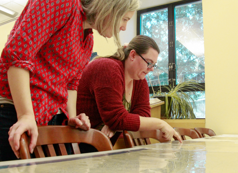 Susan Powell, left, and Jennifer Osgood discuss a map at the event.