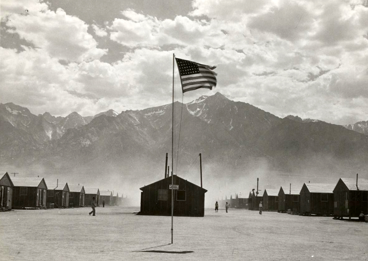 Barracks at a prison camp and American flag
