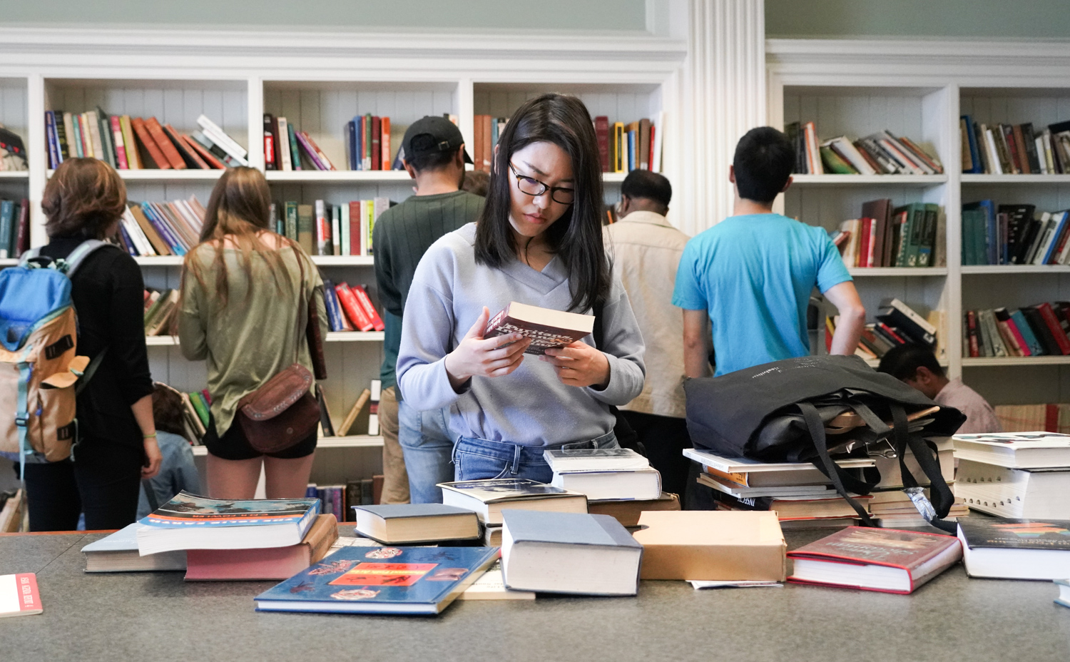 Visitors browse the $1 book sale at Doe Library on Cal Day, April 21, 2018.