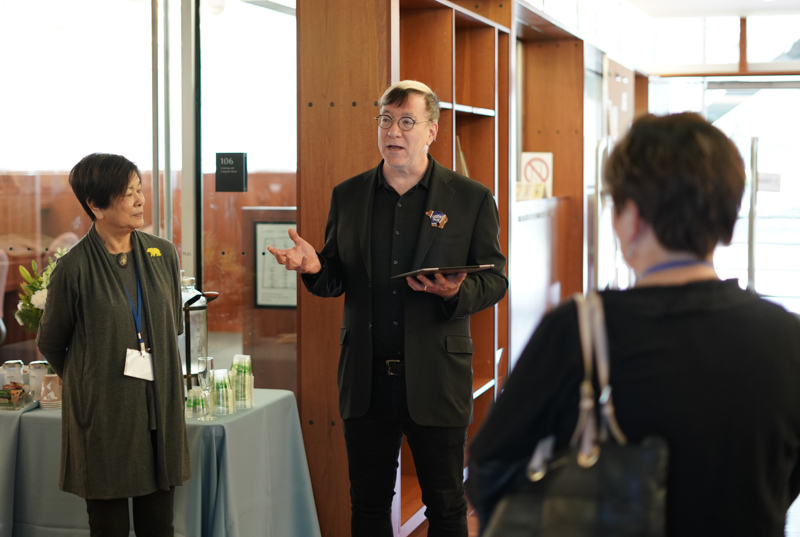 Jeffrey MacKie-Mason, University Librarian, center, welcomes donors to the Library Legacy Circle luncheon at the Music Library on Feb. 10, 2018.