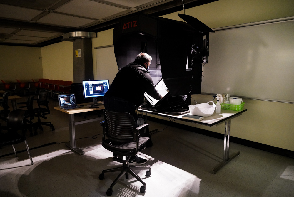 Employee scans books.