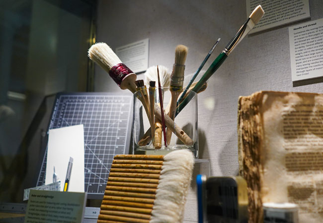 Tools in an exhibit case including brushes