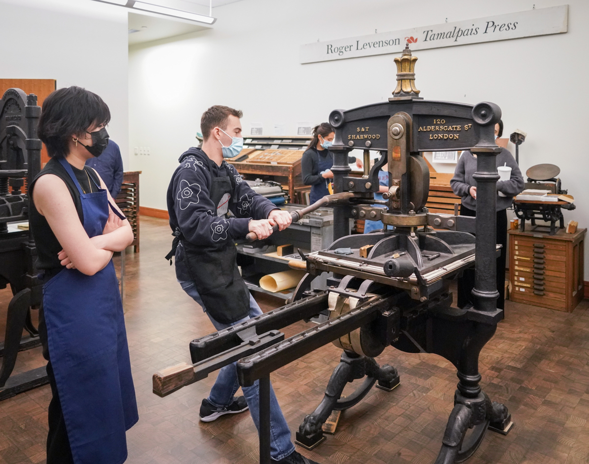 Students demonstrate using a press during class