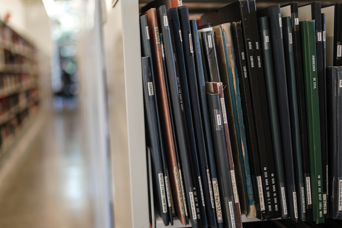 musical scores are stacked on shelves of the Music Library