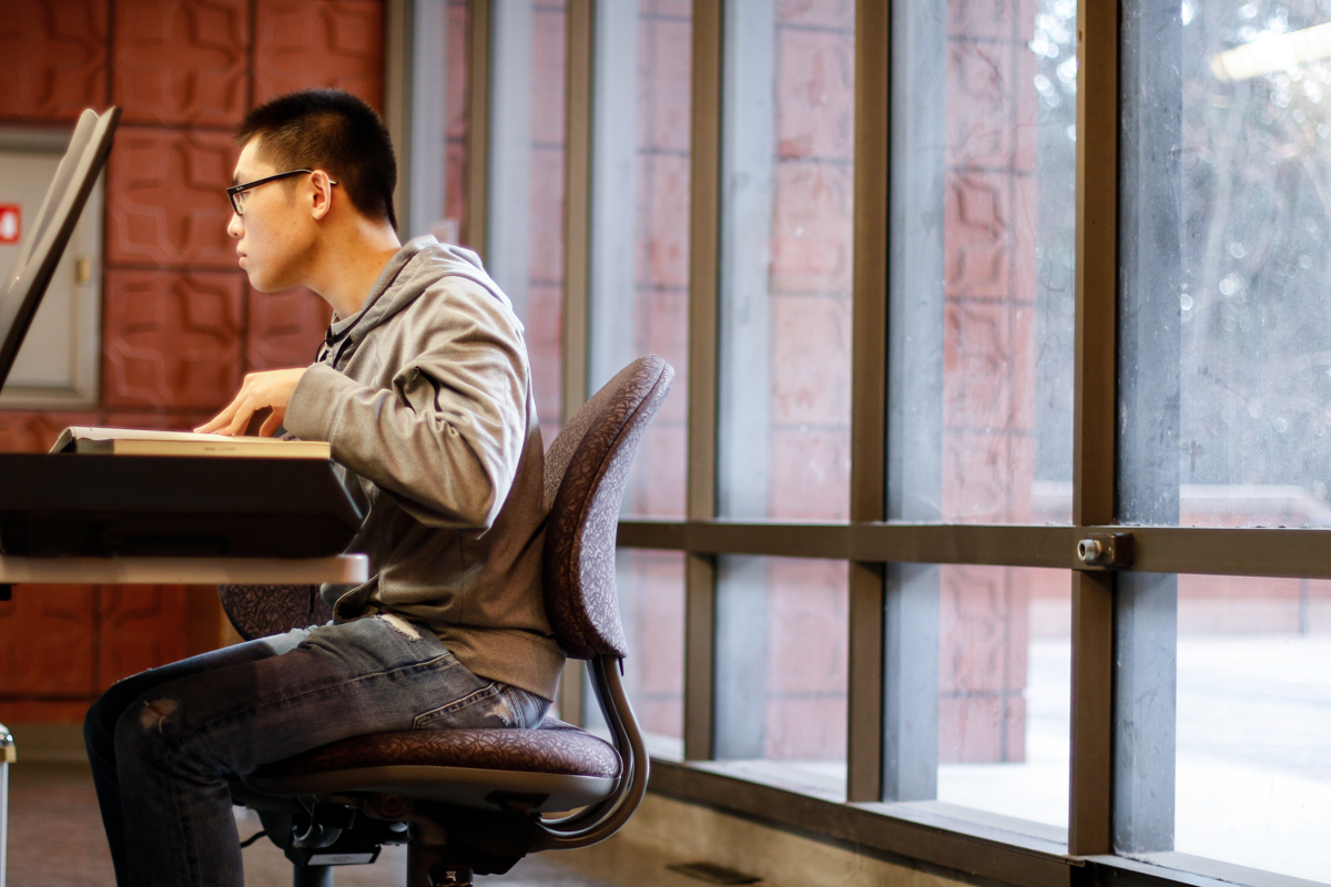 A student scans documents in a library